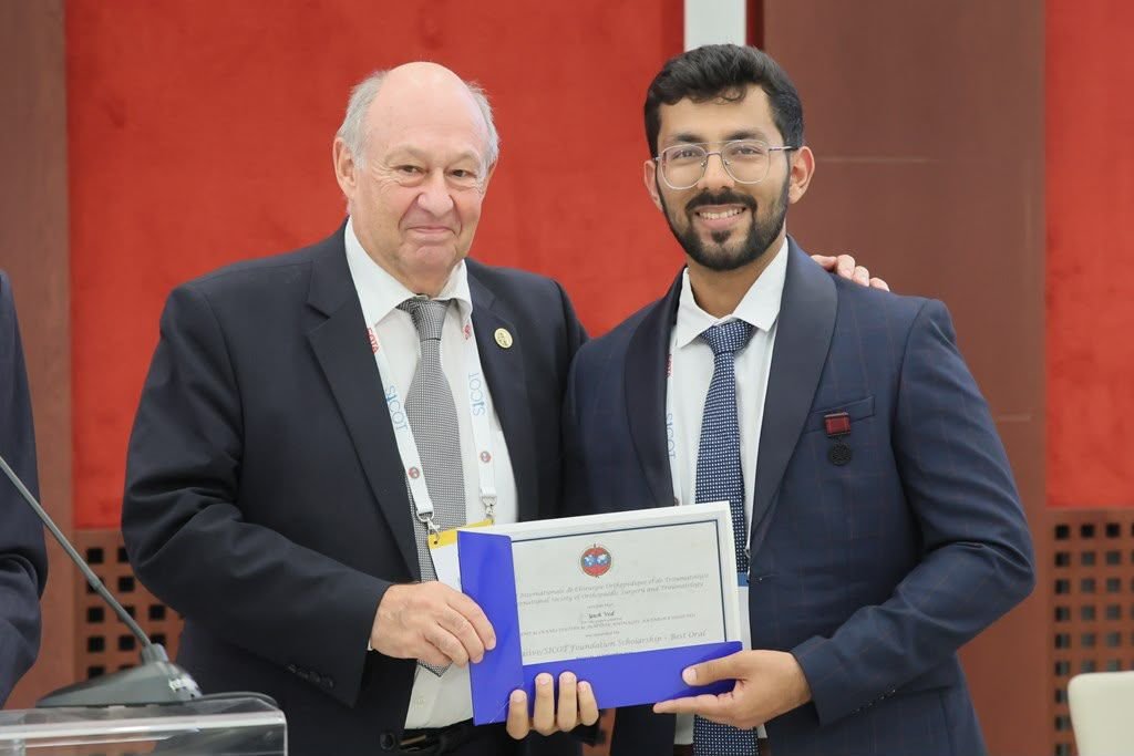 Dr. Yash Ved receiving the NuVasive/SICOT Foundation Scholarship certificate in Belgrade